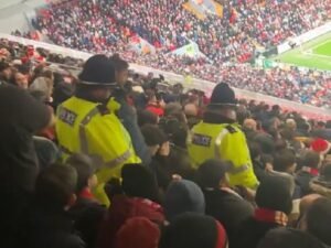 Fan spots police escorting Liverpool supporters out of Anfield for standing